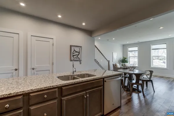 a kitchen with stainless steel appliances granite countertop a stove a refrigerator and a microwave