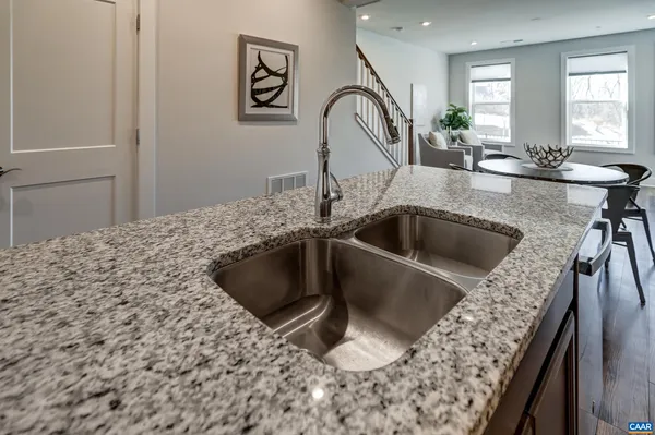 a kitchen with sink cabinets and stainless steel appliances