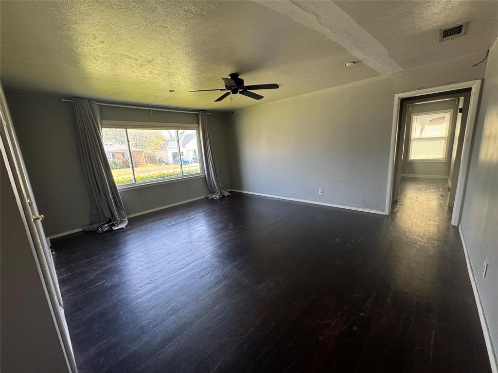 629 Harrison Lane Hurst, TX 76053 - Photo 4 of 20 an empty room with wooden floor and windows
