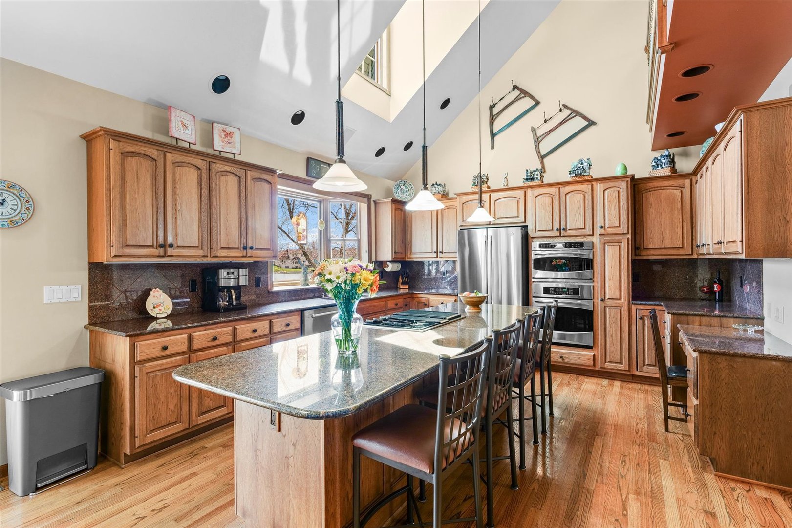 2204 Edgewater Place Champaign, IL 61822 - Photo 11 of 83 a kitchen with stainless steel appliances kitchen island granite countertop a table chairs and a refrigerator