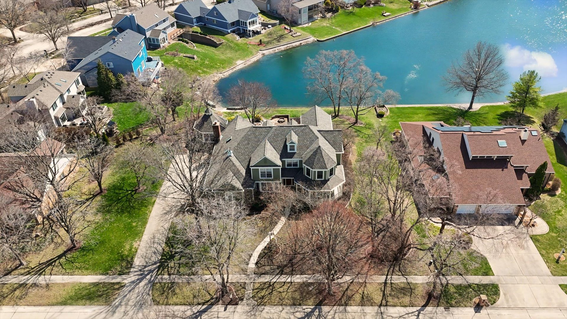 2204 Edgewater Place Champaign, IL 61822 - Photo 5 of 83 an aerial view of a house with a yard and lake view