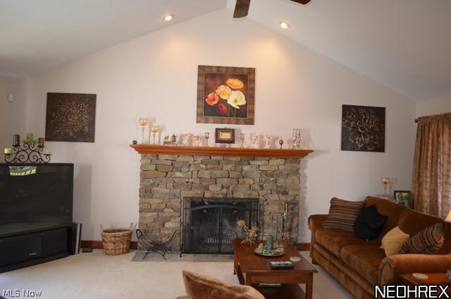 7608 Dewey Road Thompson, OH 44086 - Photo 3 of 25 Great room with vaulted ceiling, fieldstone fireplace, carpeting and sliders to a deck which overlooks the pool and rear yard.