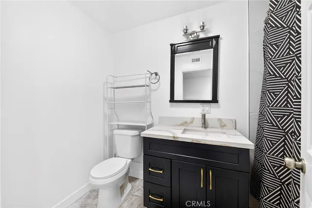 a bathroom with a sink toilet and mirror
