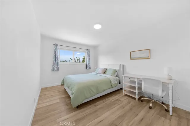 a bedroom with a bed and a desk