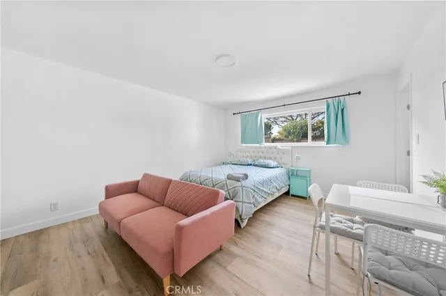 a bedroom with a bed couch and window