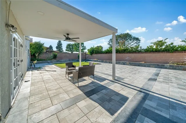 a view of a patio with a dining table and chairs