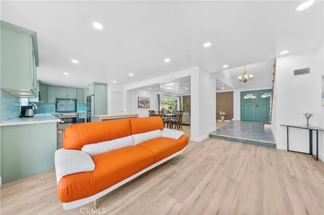 a view of kitchen with kitchen island stainless steel appliances granite countertop sink and window