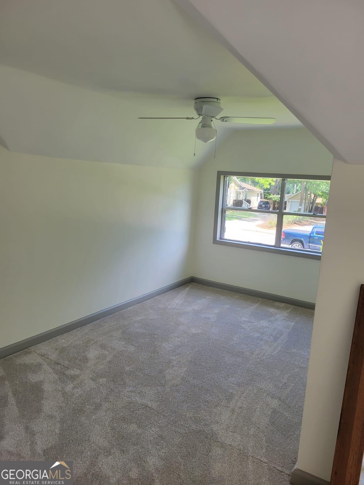6127 Floyd Street Northeast Covington, GA 30014 - Photo 13 of 23 an empty room with windows and ceiling fan