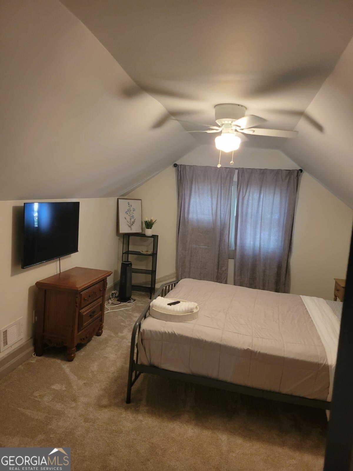 6127 Floyd Street Northeast Covington, GA 30014 - Photo 14 of 23 a bedroom with a bed and a flat screen tv