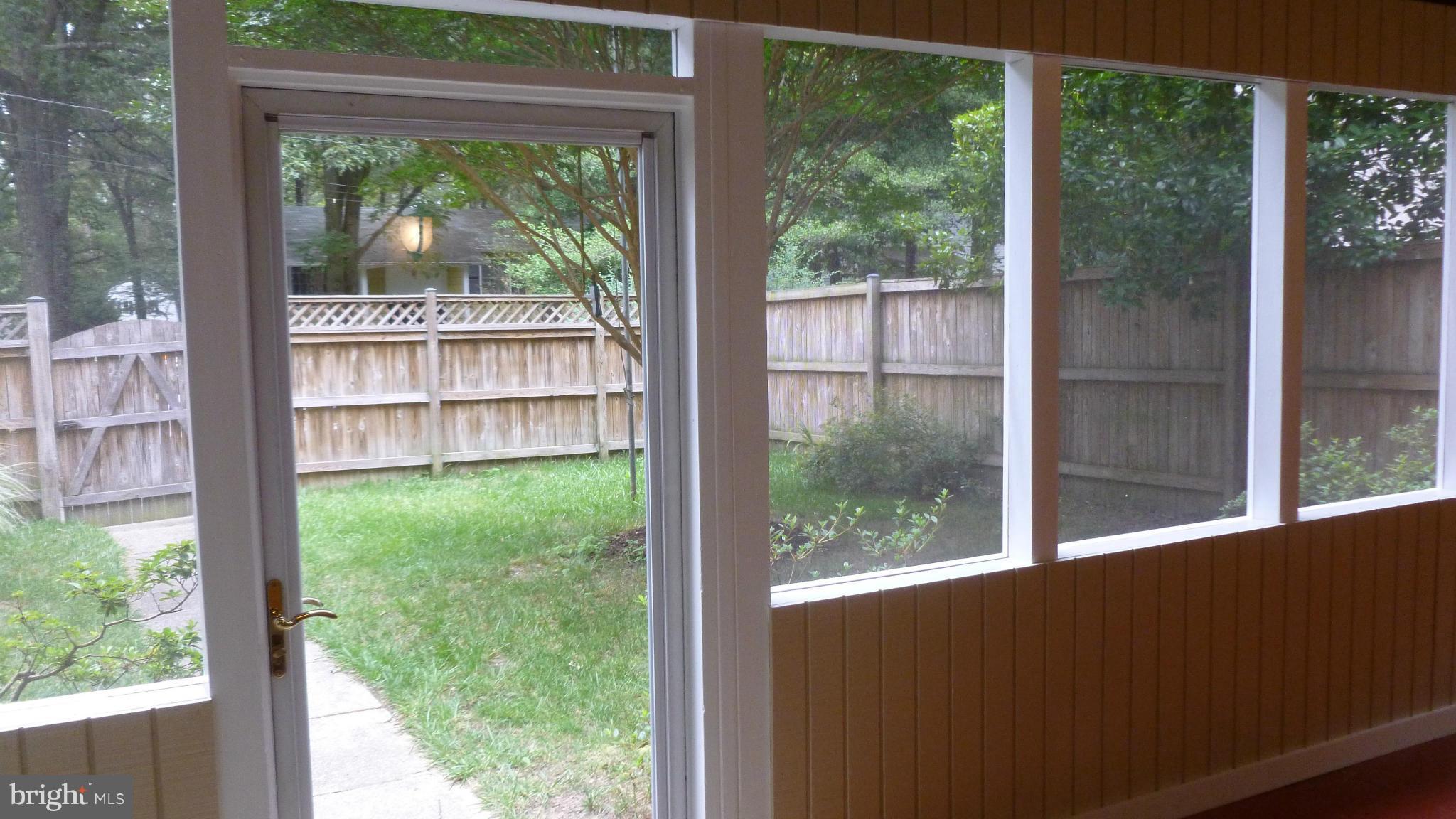Front porch looking toward fenced front yard.