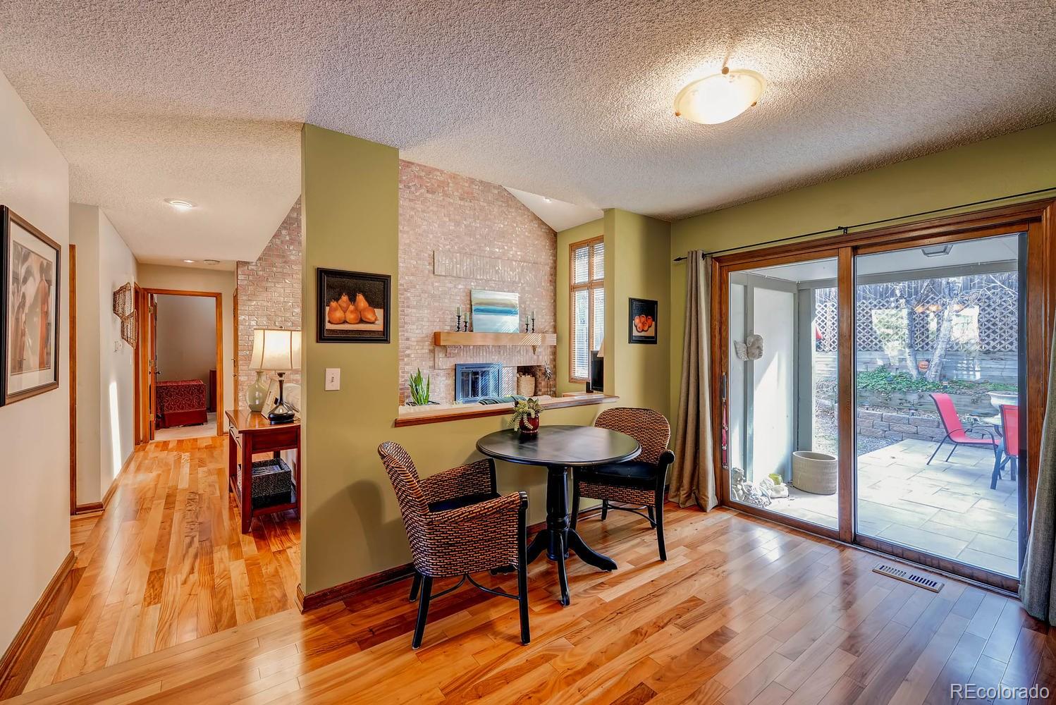 8110 Sweet Water Road Lone Tree, CO 80124 - Photo 14 of 34 a dining room with furniture a floor to ceiling window and wooden floor