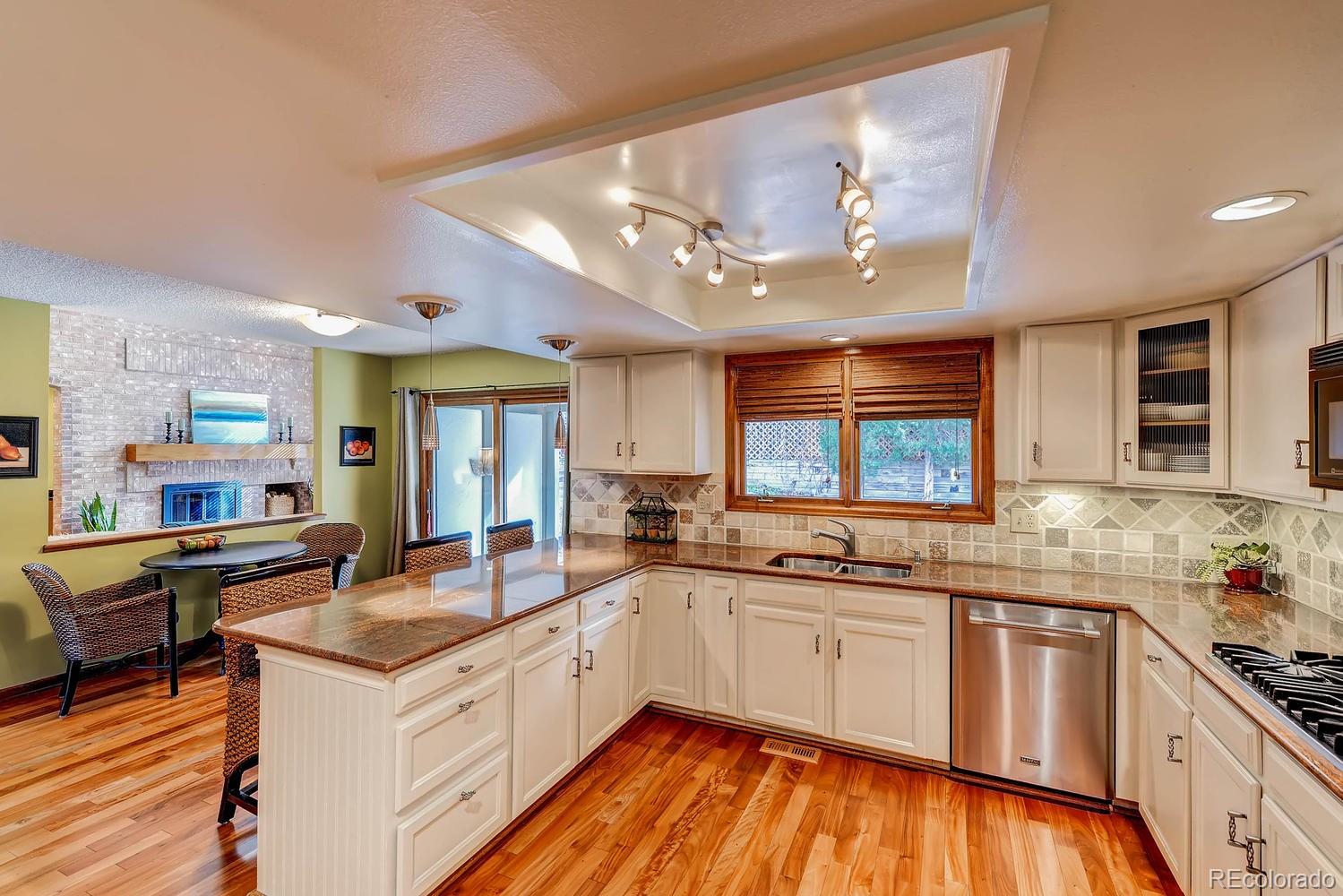 8110 Sweet Water Road Lone Tree, CO 80124 - Photo 15 of 34 a kitchen with stainless steel appliances granite countertop a sink and cabinets