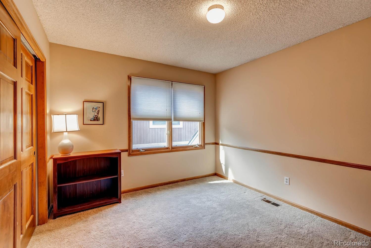 8110 Sweet Water Road Lone Tree, CO 80124 - Photo 23 of 34 a view of an empty room with a window