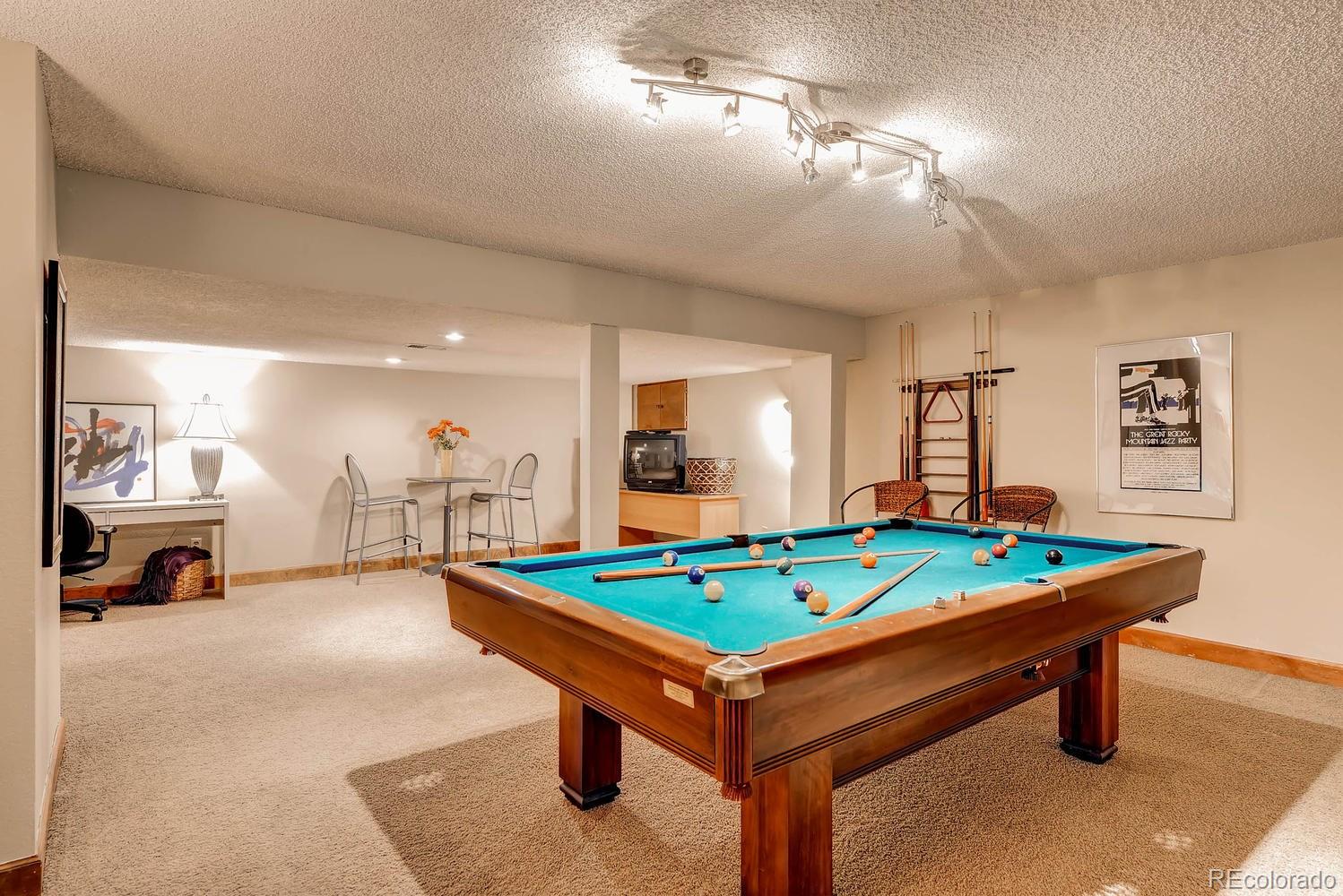 8110 Sweet Water Road Lone Tree, CO 80124 - Photo 25 of 34 a room with pool table and flat screen tv
