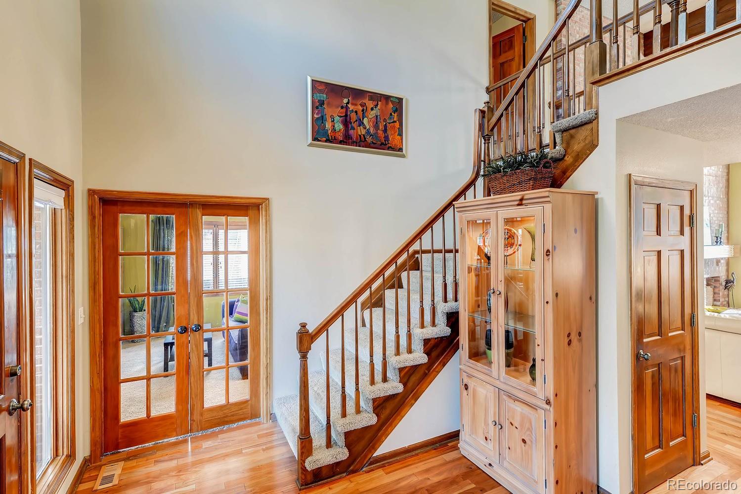 8110 Sweet Water Road Lone Tree, CO 80124 - Photo 4 of 34 a view of staircase with lots of frames on wall and a window