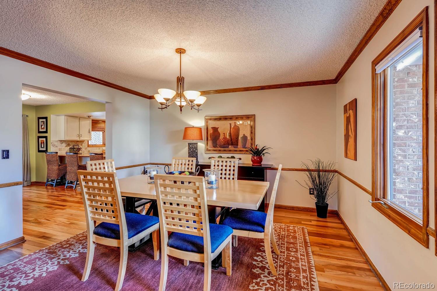 8110 Sweet Water Road Lone Tree, CO 80124 - Photo 5 of 34 a view of a dining room with furniture window and wooden floor