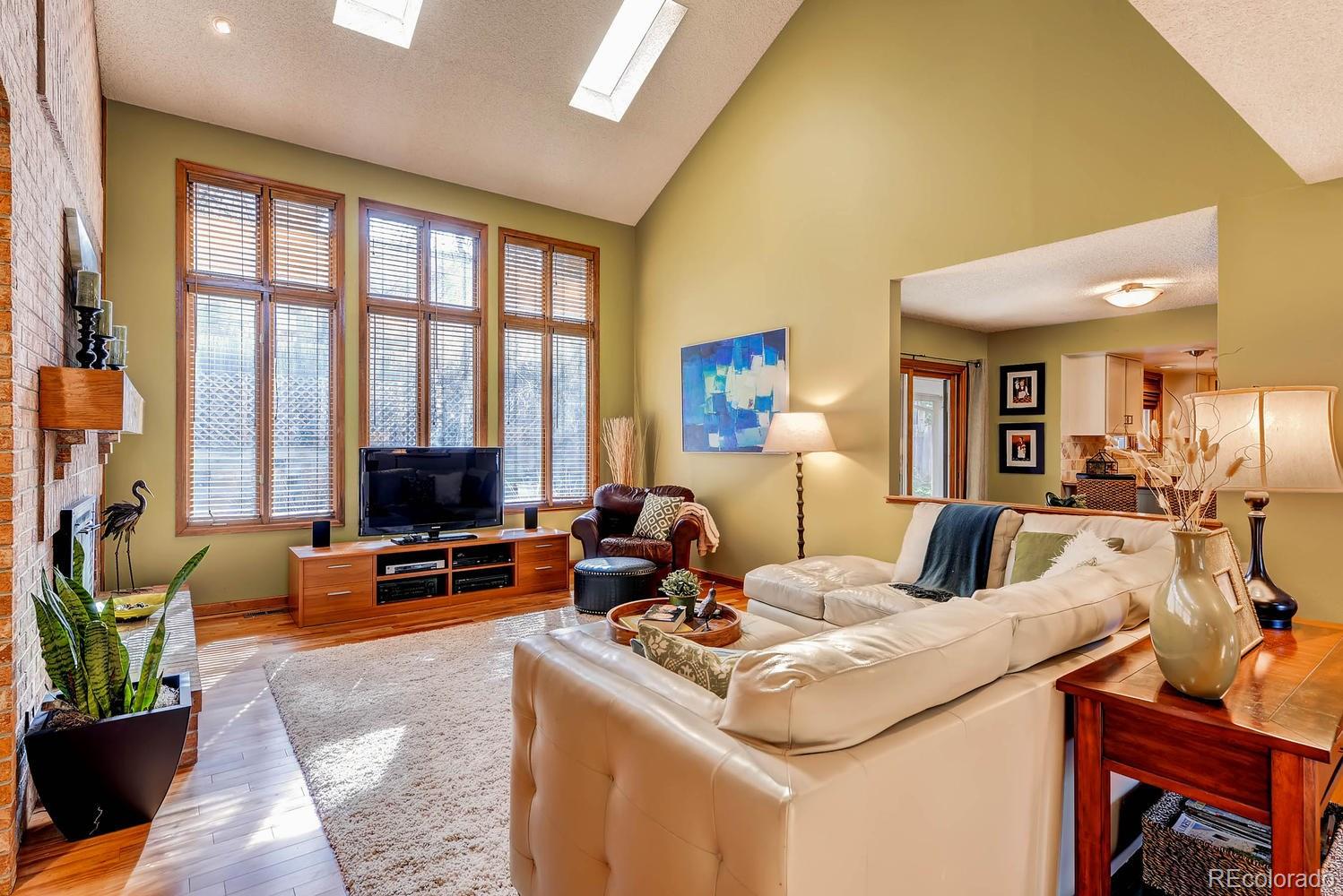 8110 Sweet Water Road Lone Tree, CO 80124 - Photo 6 of 34 a living room with furniture and a flat screen tv