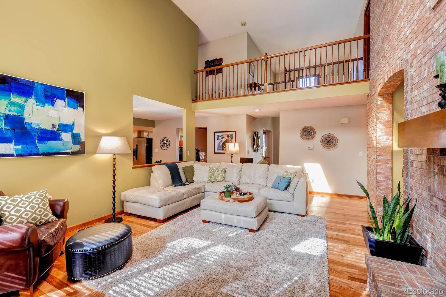 8110 Sweet Water Road Lone Tree, CO 80124 - Photo 7 of 34 a living room with furniture or couch and a potted plant
