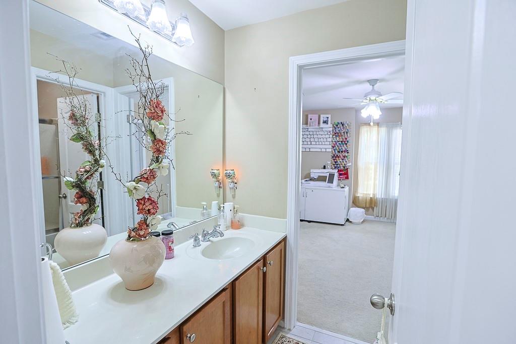 300 Hampton Place Canton, GA 30115 - Photo 38 of 82 a bathroom with a sink vanity tub and a mirror