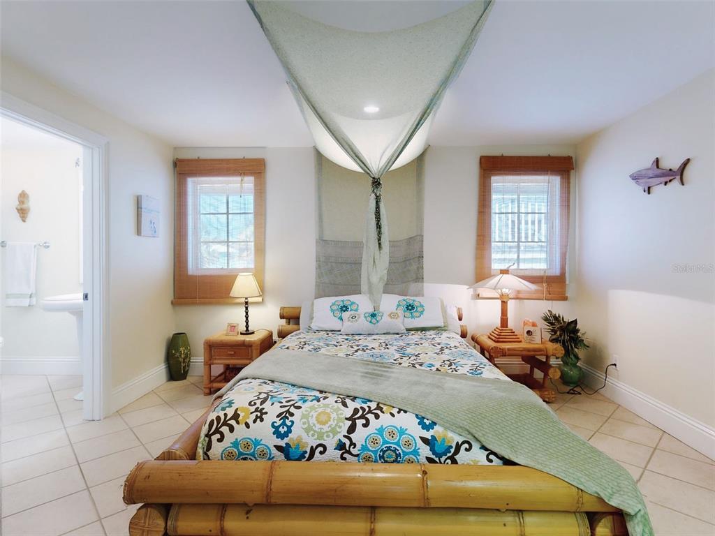 1913 Hill Street, Unit 2 New Smyrna Beach, FL 32169 - Photo 11 of 90 a bedroom with a bed and wooden floor