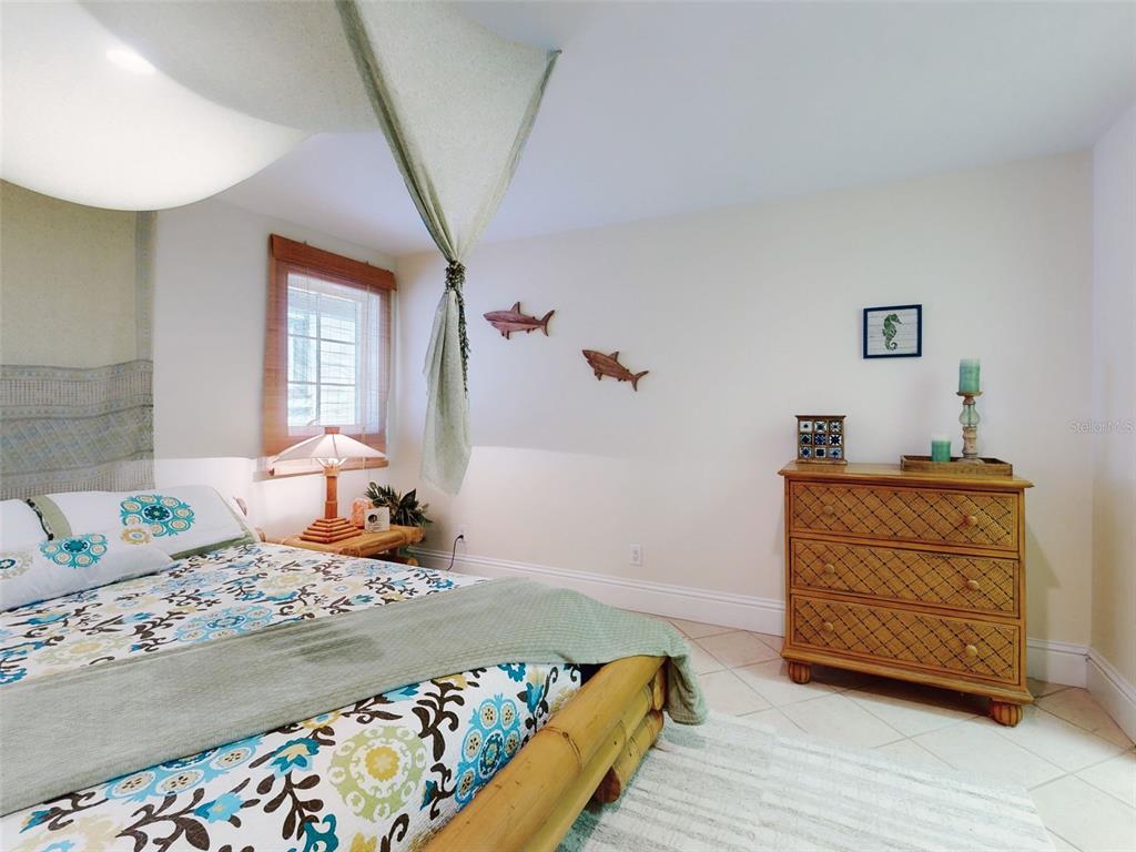 1913 Hill Street, Unit 2 New Smyrna Beach, FL 32169 - Photo 15 of 90 a bedroom with a bed and a dresser in it