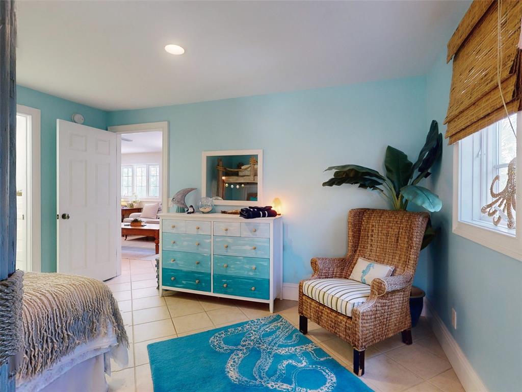 1913 Hill Street, Unit 2 New Smyrna Beach, FL 32169 - Photo 17 of 90 a living room with furniture and a flat screen tv