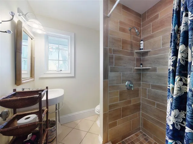 a kitchen with a sink a stove and chandelier