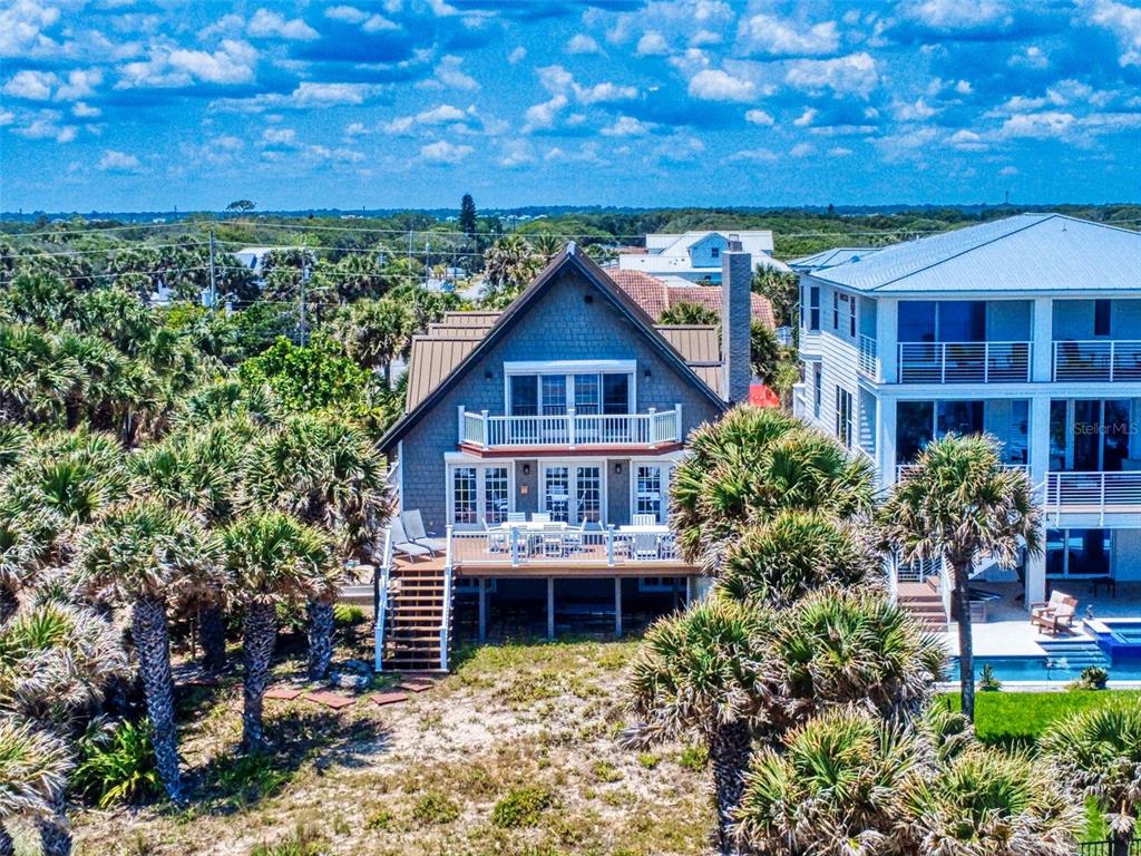 1913 Hill Street, Unit 2 New Smyrna Beach, FL 32169 - Photo 2 of 90 a view of a house with a small yard and wooden fence