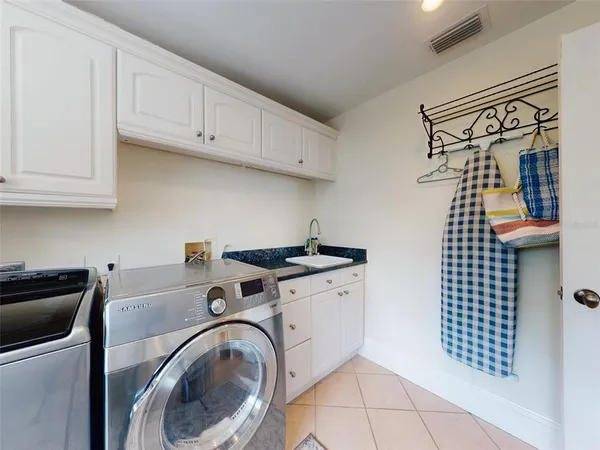 a kitchen with stainless steel appliances granite countertop a stove a sink and a dining table with garden view