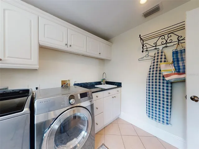 a kitchen with stainless steel appliances granite countertop a stove a sink and a dining table with garden view