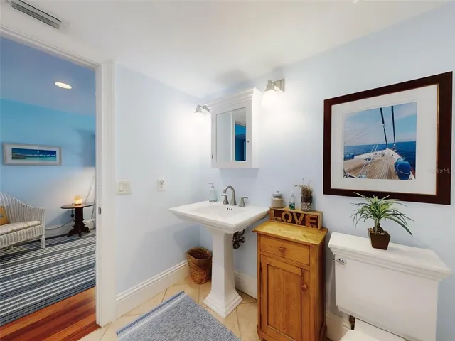 a bathroom with a sink a mirror and a toilet