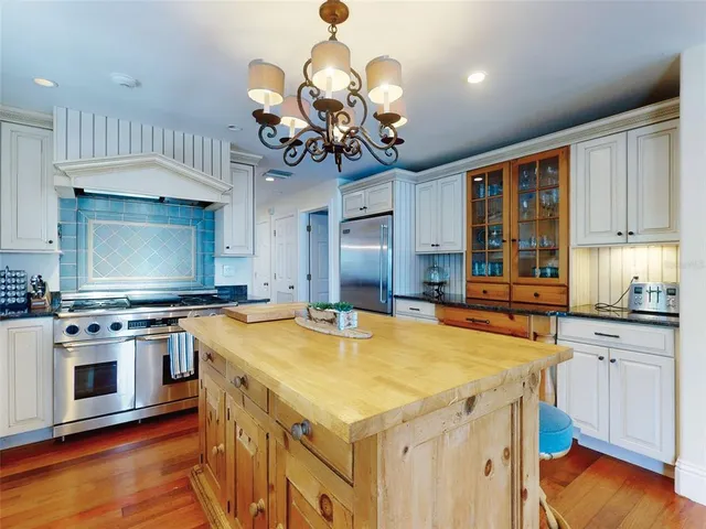 a view of a patio with table and chairs with wooden floor and fence