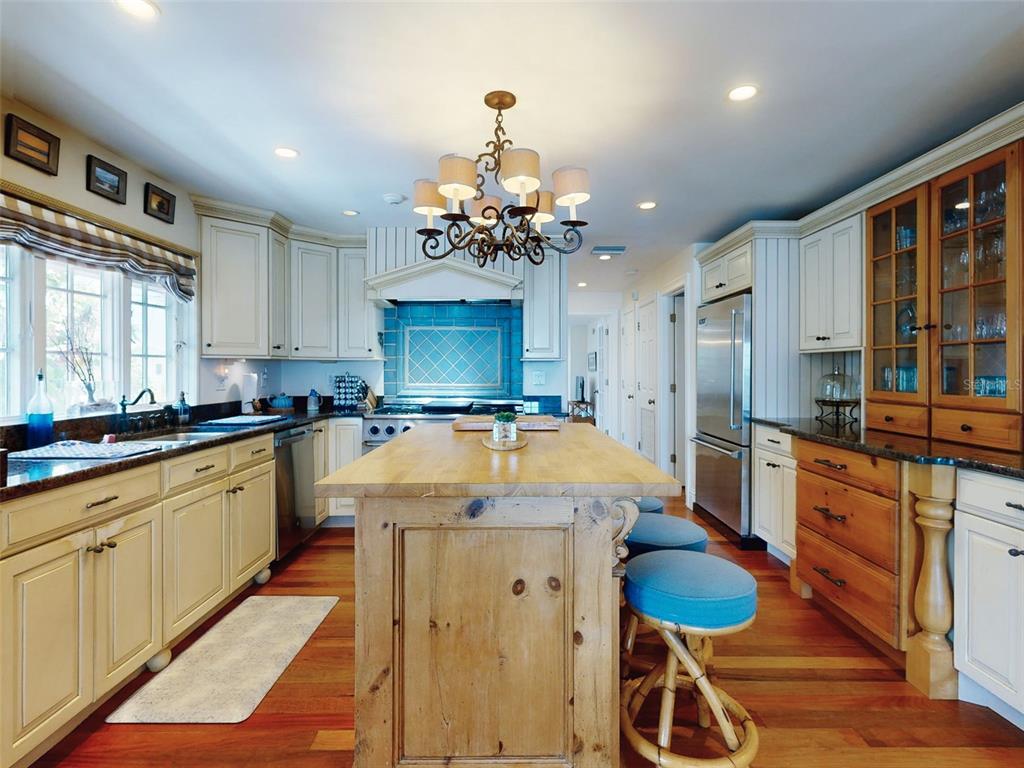 1913 Hill Street, Unit 2 New Smyrna Beach, FL 32169 - Photo 29 of 90 a large kitchen with lots of counter space and chandelier