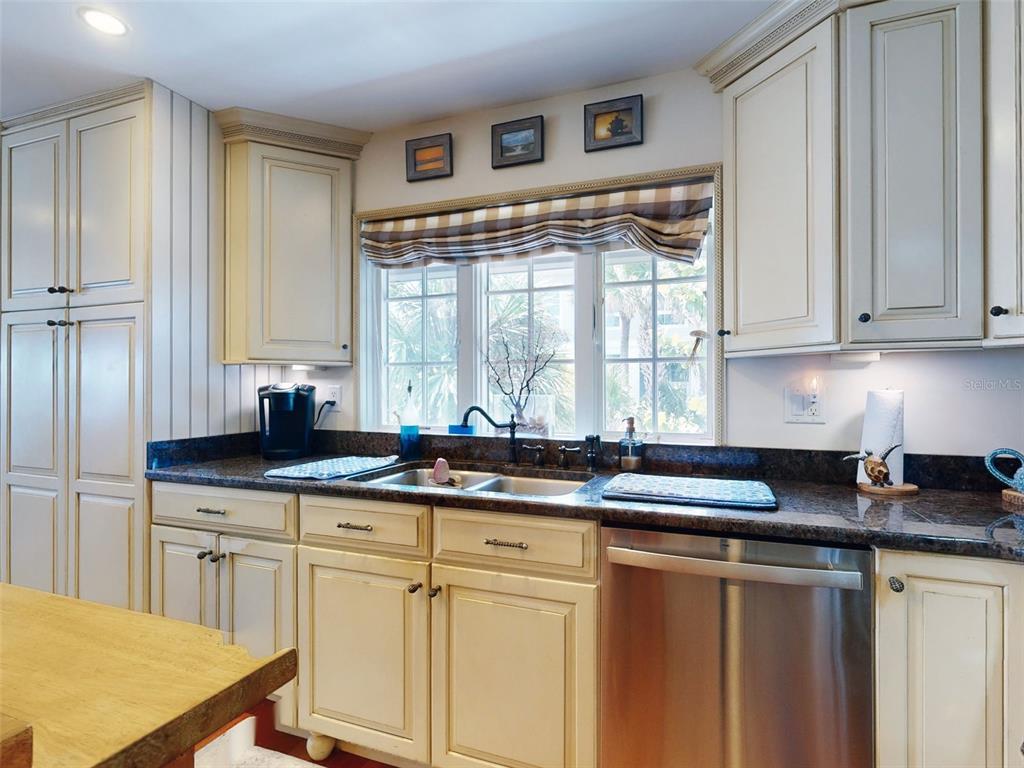 1913 Hill Street, Unit 2 New Smyrna Beach, FL 32169 - Photo 30 of 90 a kitchen with stainless steel appliances granite countertop a sink and a cabinets