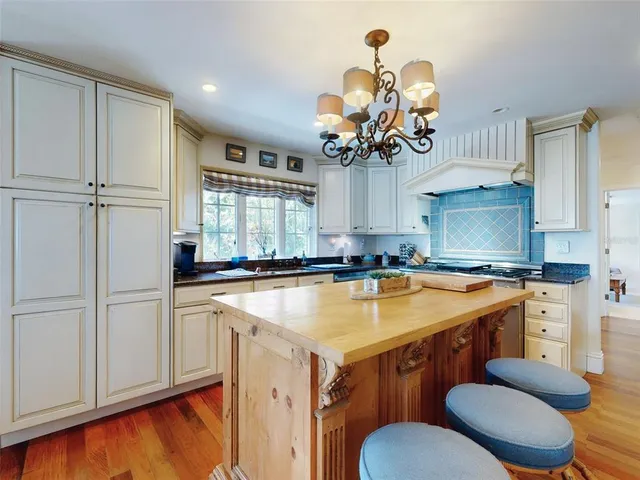 a bedroom with bed and wooden floor