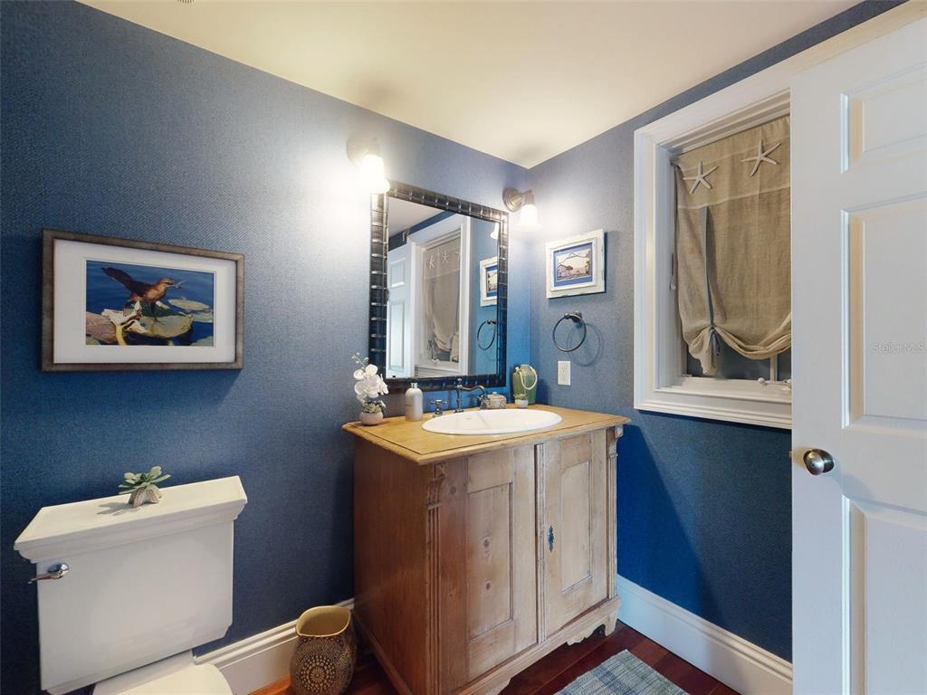 1913 Hill Street, Unit 2 New Smyrna Beach, FL 32169 - Photo 42 of 90 a bathroom with a sink a mirror and a toilet