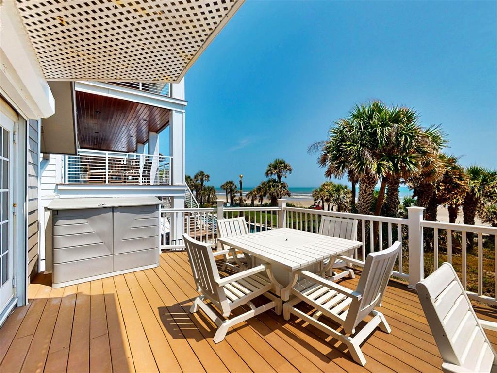 1913 Hill Street, Unit 2 New Smyrna Beach, FL 32169 - Photo 44 of 90 a view of a patio with table and chairs with wooden floor and fence