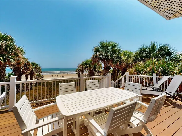 a view of a balcony dining table and chairs