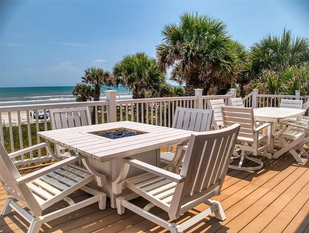 a view of a chairs and table on the deck