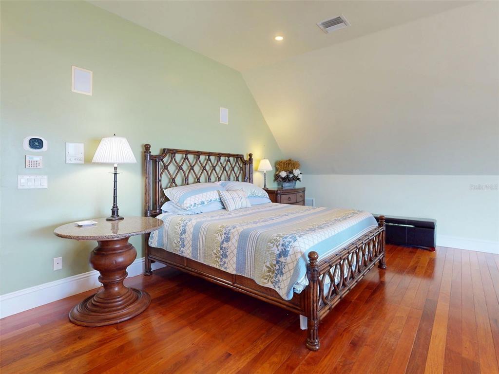 1913 Hill Street, Unit 2 New Smyrna Beach, FL 32169 - Photo 53 of 90 a bedroom with bed and wooden floor