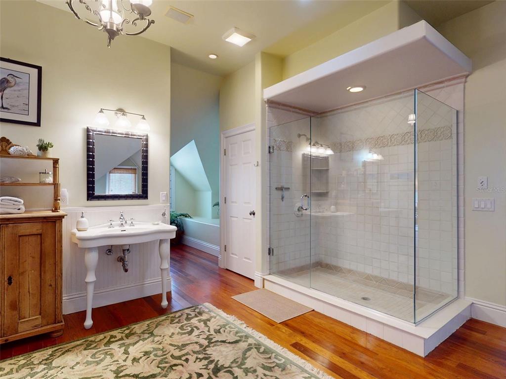 1913 Hill Street, Unit 2 New Smyrna Beach, FL 32169 - Photo 60 of 90 a spacious bathroom with a sink shower and mirror