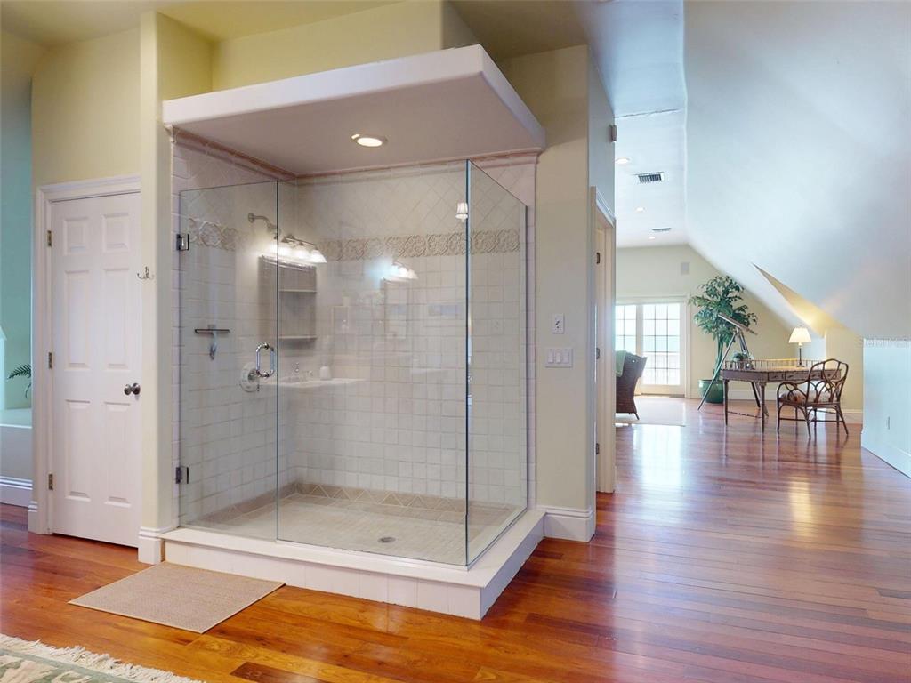 1913 Hill Street, Unit 2 New Smyrna Beach, FL 32169 - Photo 67 of 90 a bathroom with a glass shower door and a glass door