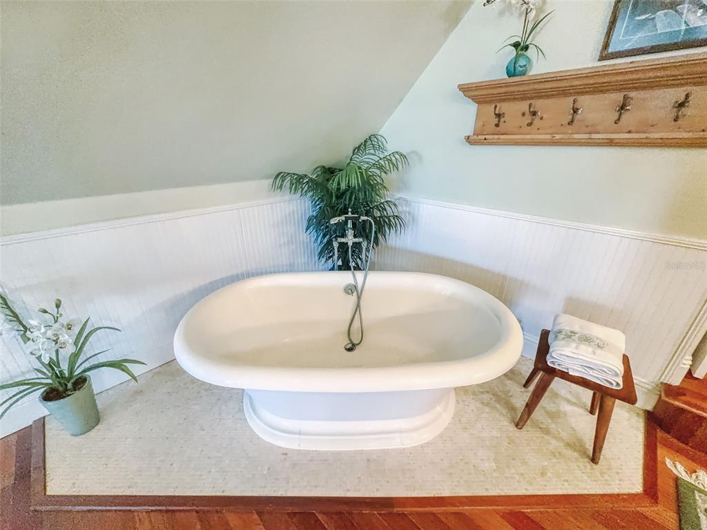 1913 Hill Street, Unit 2 New Smyrna Beach, FL 32169 - Photo 68 of 90 a white bath tub sitting in a bathroom