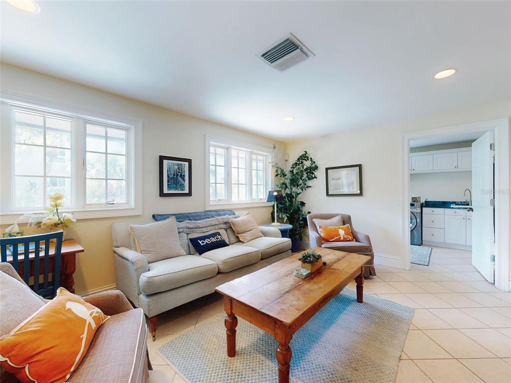 1913 Hill Street, Unit 2 New Smyrna Beach, FL 32169 - Photo 7 of 90 a living room with furniture a rug and a window