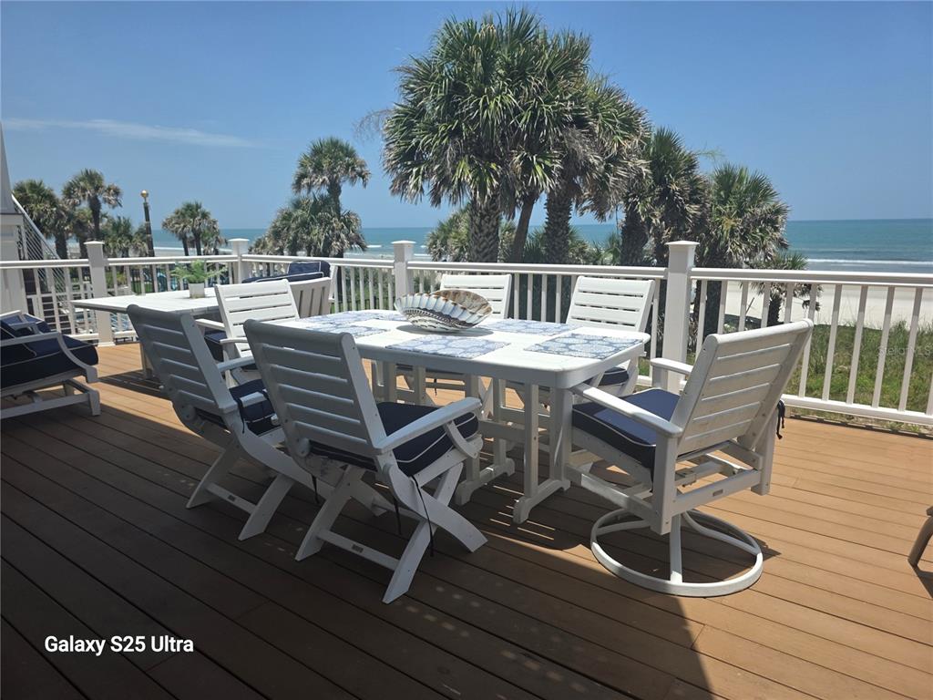 1913 Hill Street, Unit 2 New Smyrna Beach, FL 32169 - Photo 82 of 90 a view of a chairs and table on the deck