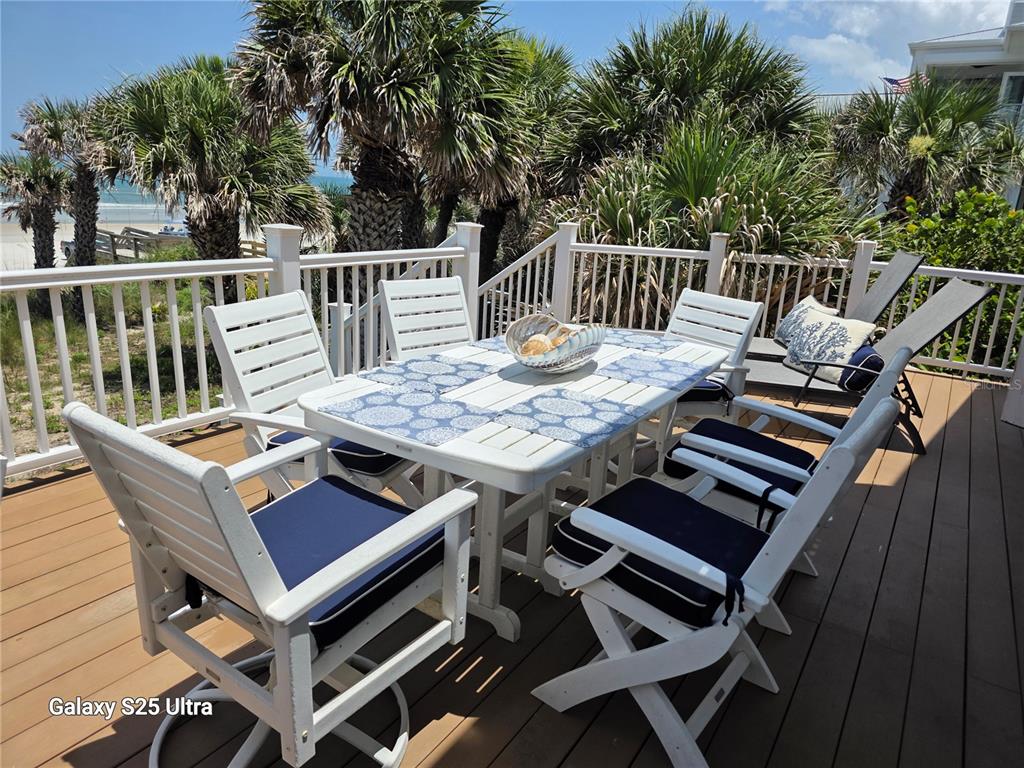 1913 Hill Street, Unit 2 New Smyrna Beach, FL 32169 - Photo 85 of 90 a view of a dinning tables and chairs on the deck
