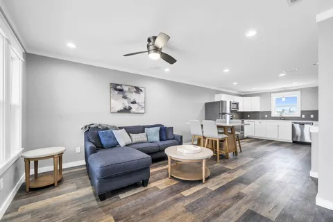 a living room with furniture a window and kitchen view
