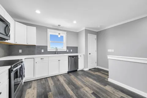 a large white bed in a white room