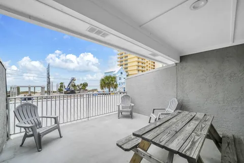 a view of a chairs and table in patio