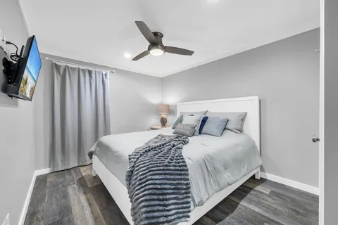 a bedroom with a bed and a chandelier